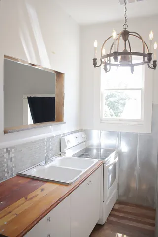 a view of a hallway with wooden floor and entryway