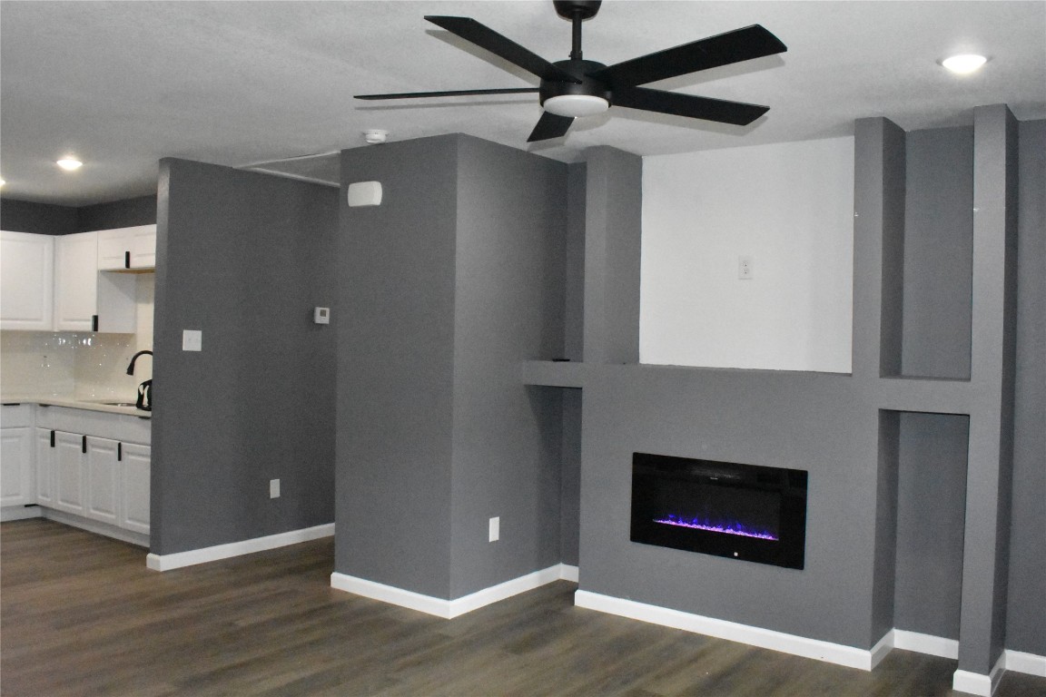 204 Texas Daisetta, TX 77533 - Photo 5 of 21 a open kitchen with stainless steel appliances granite countertop a fireplace and a wooden floor