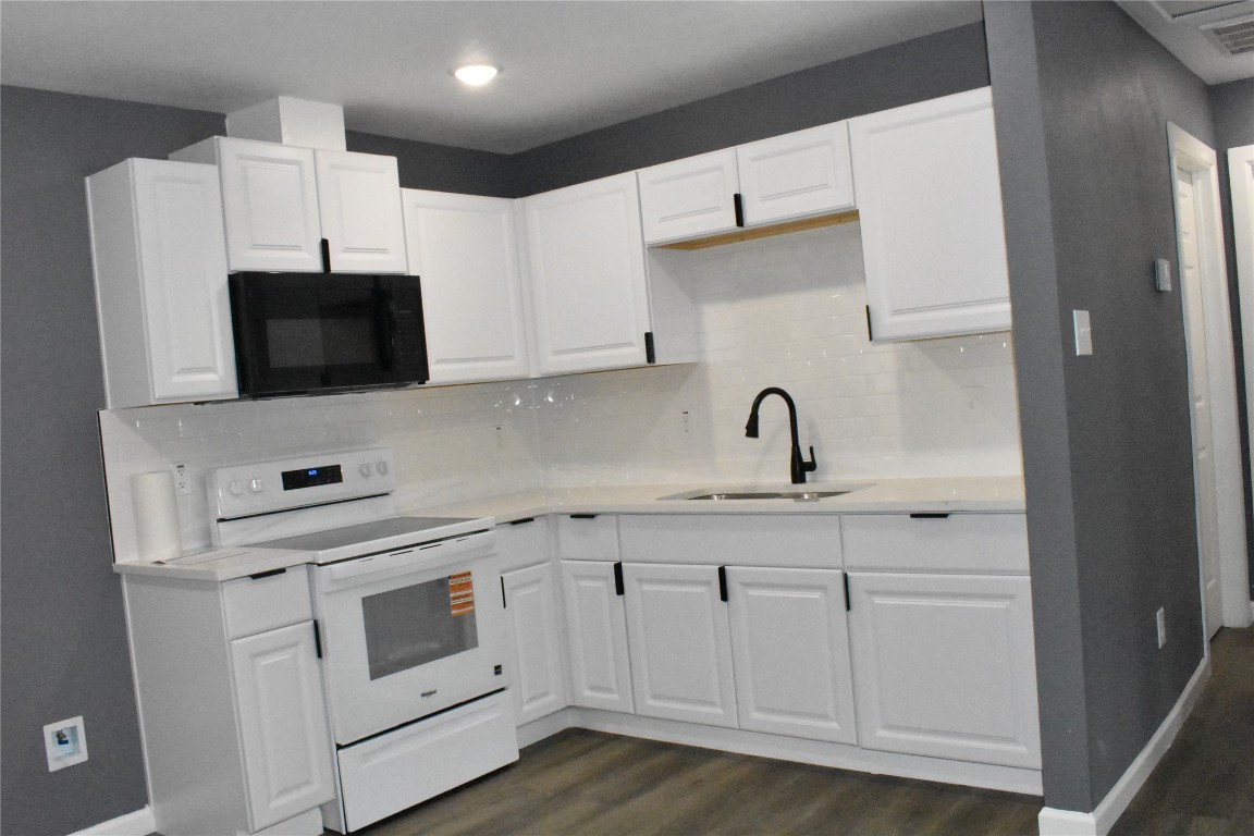 204 Texas Daisetta, TX 77533 - Photo 8 of 21 a kitchen with white cabinets and white appliances