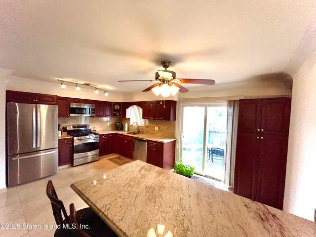 a kitchen with a chandelier furniture and refrigerator
