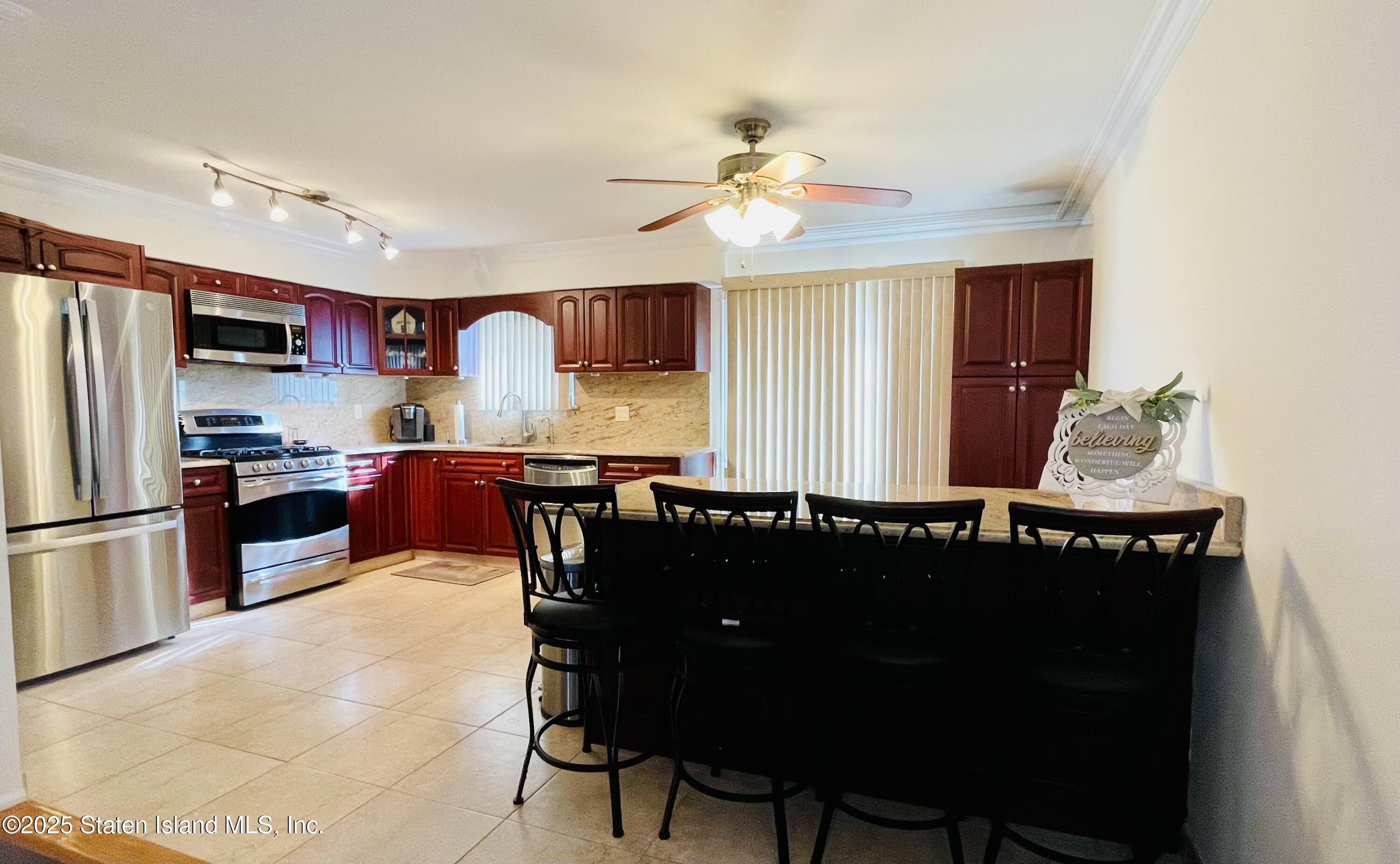 10 Token Street Staten Island, NY 10312 - Photo 15 of 39 a kitchen with a chandelier furniture and refrigerator