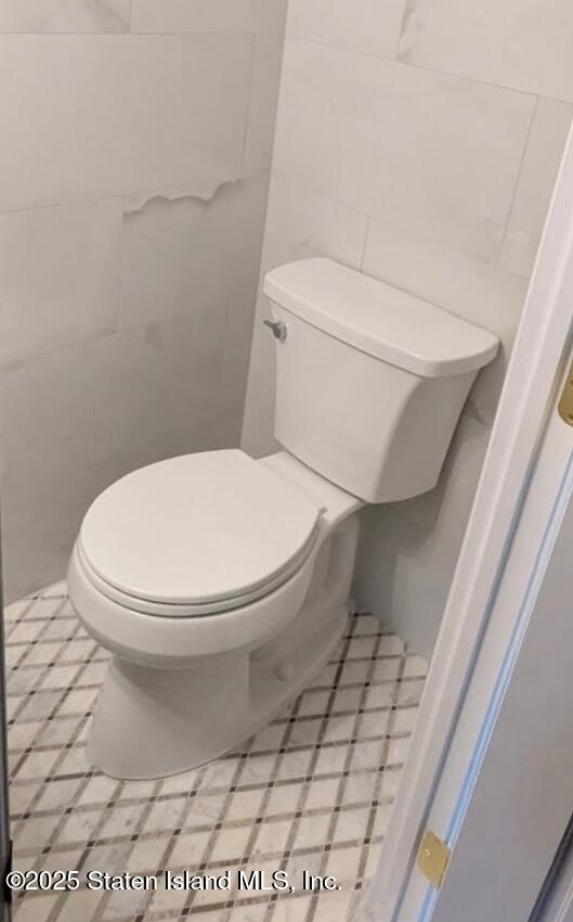 10 Token Street Staten Island, NY 10312 - Photo 17 of 39 a white toilet sitting next to a white cabinet