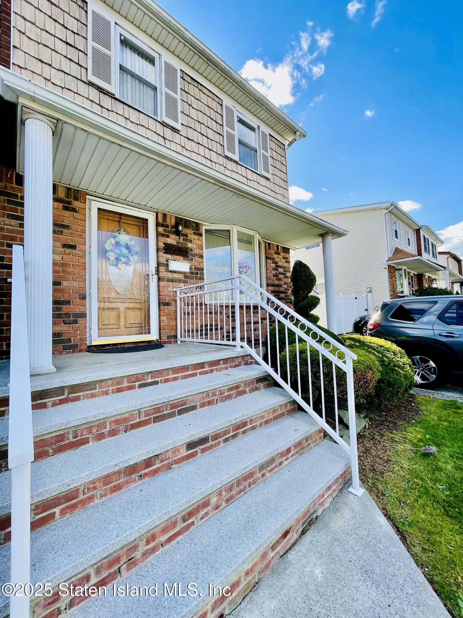 10 Token Street Staten Island, NY 10312 - Photo 2 of 39 a front view of a house with a yard