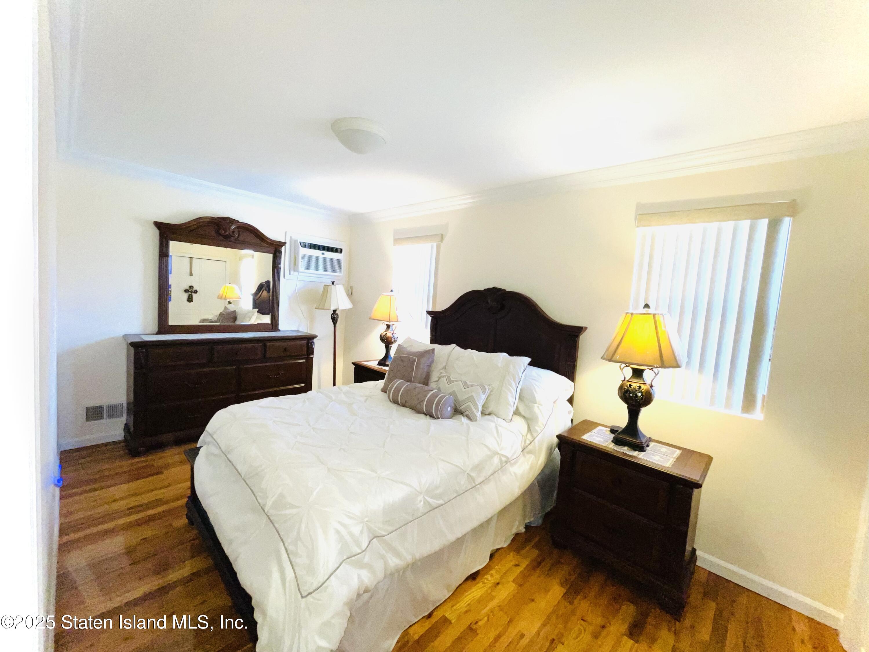 10 Token Street Staten Island, NY 10312 - Photo 24 of 39 a bedroom with a bed and a dresser