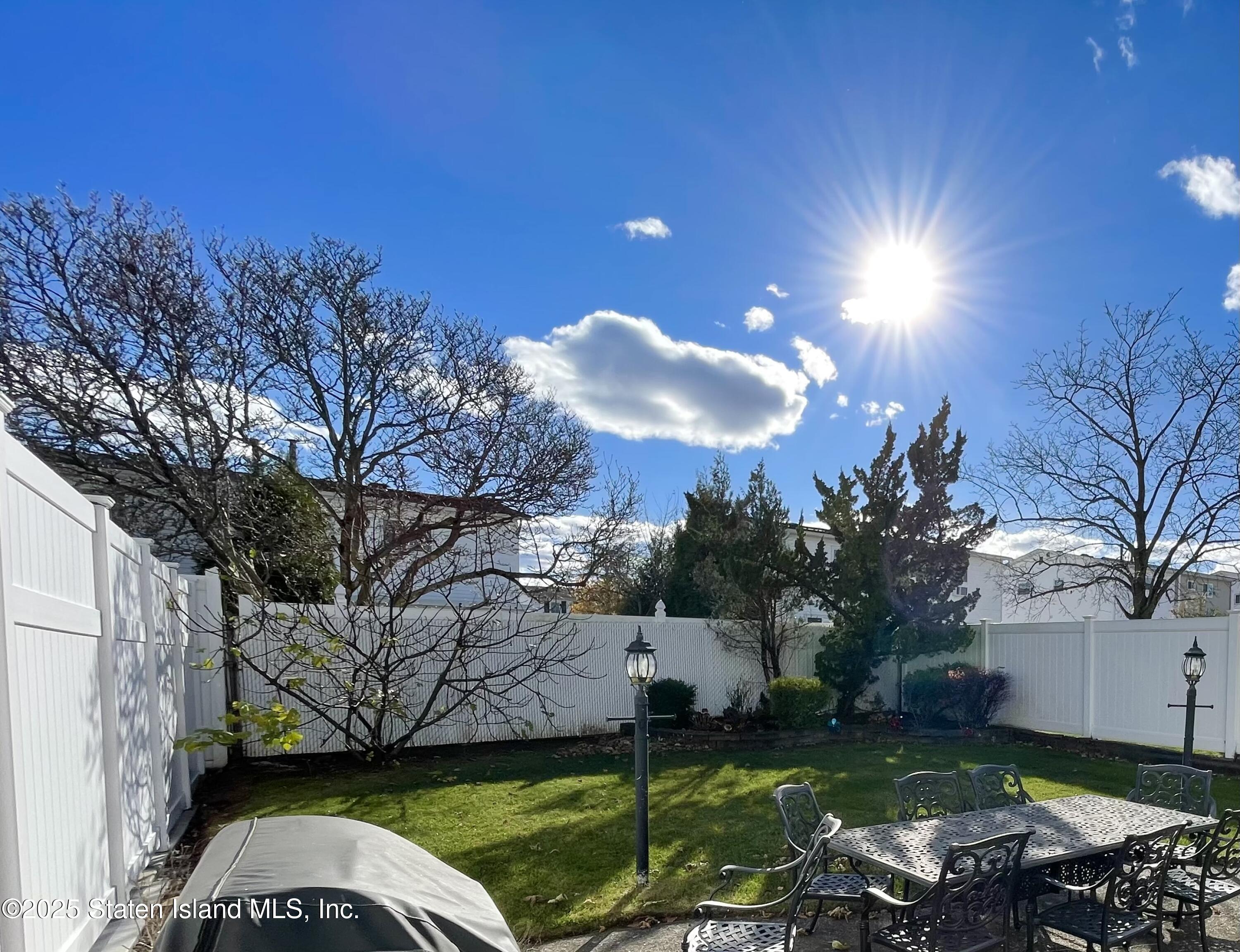 10 Token Street Staten Island, NY 10312 - Photo 39 of 39 a view of a backyard with couches plants and large trees