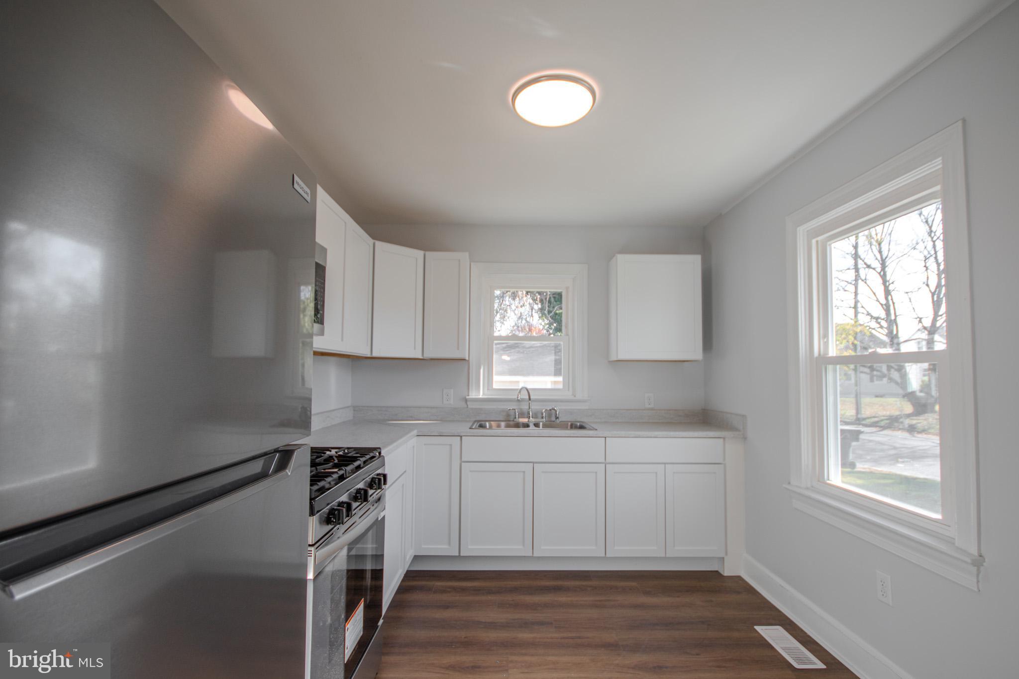 131 Truitt Street Salisbury, MD 21804 - Photo 12 of 29 a kitchen with a sink a window and cabinets