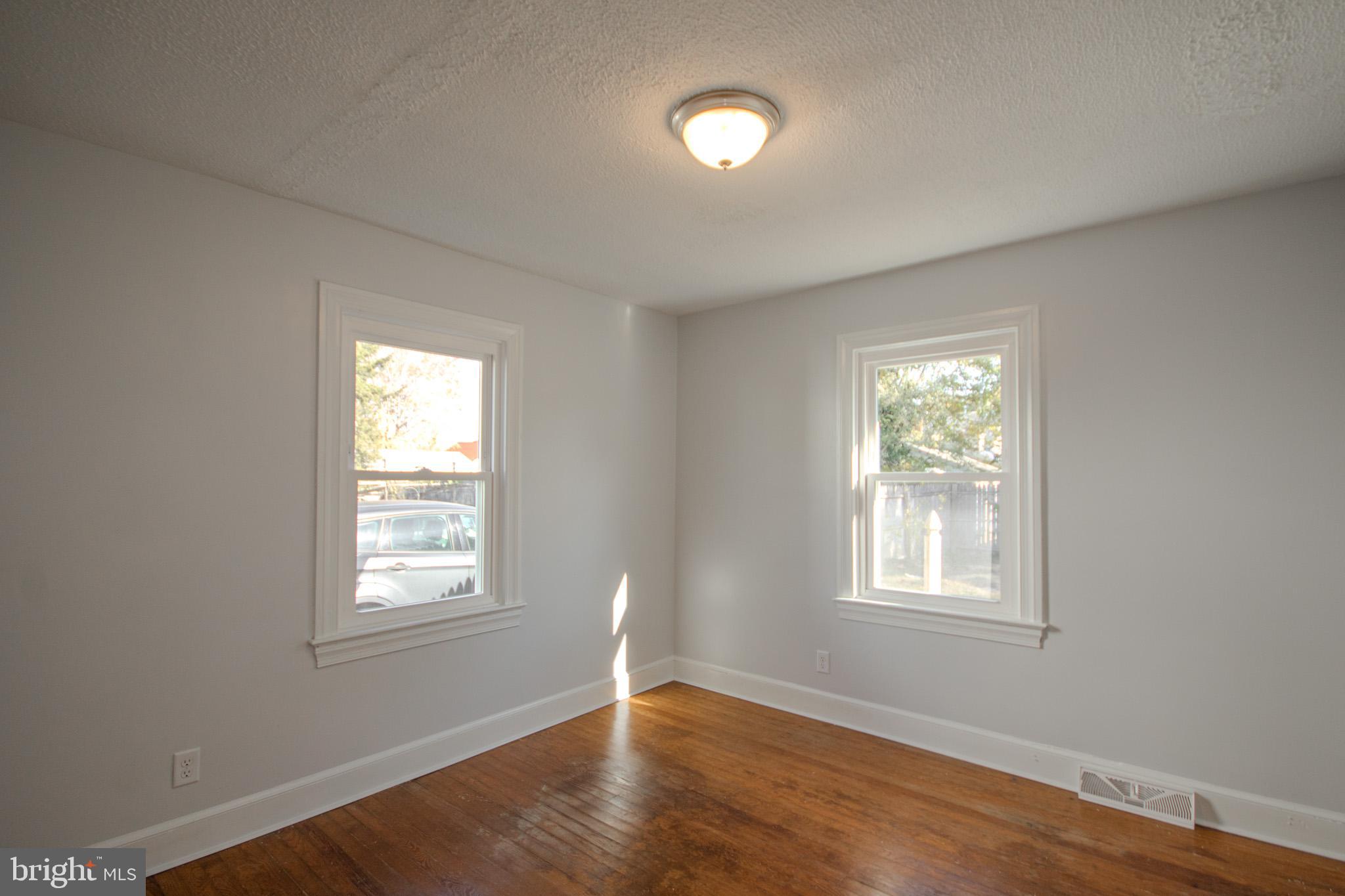 131 Truitt Street Salisbury, MD 21804 - Photo 15 of 29 a view of an empty room with wooden floor and a window