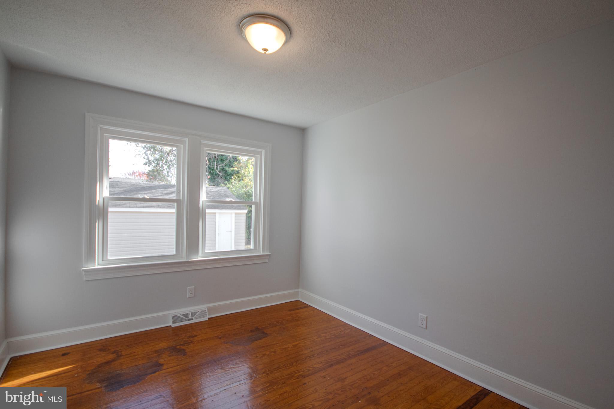 131 Truitt Street Salisbury, MD 21804 - Photo 19 of 29 an empty room with wooden floor and windows