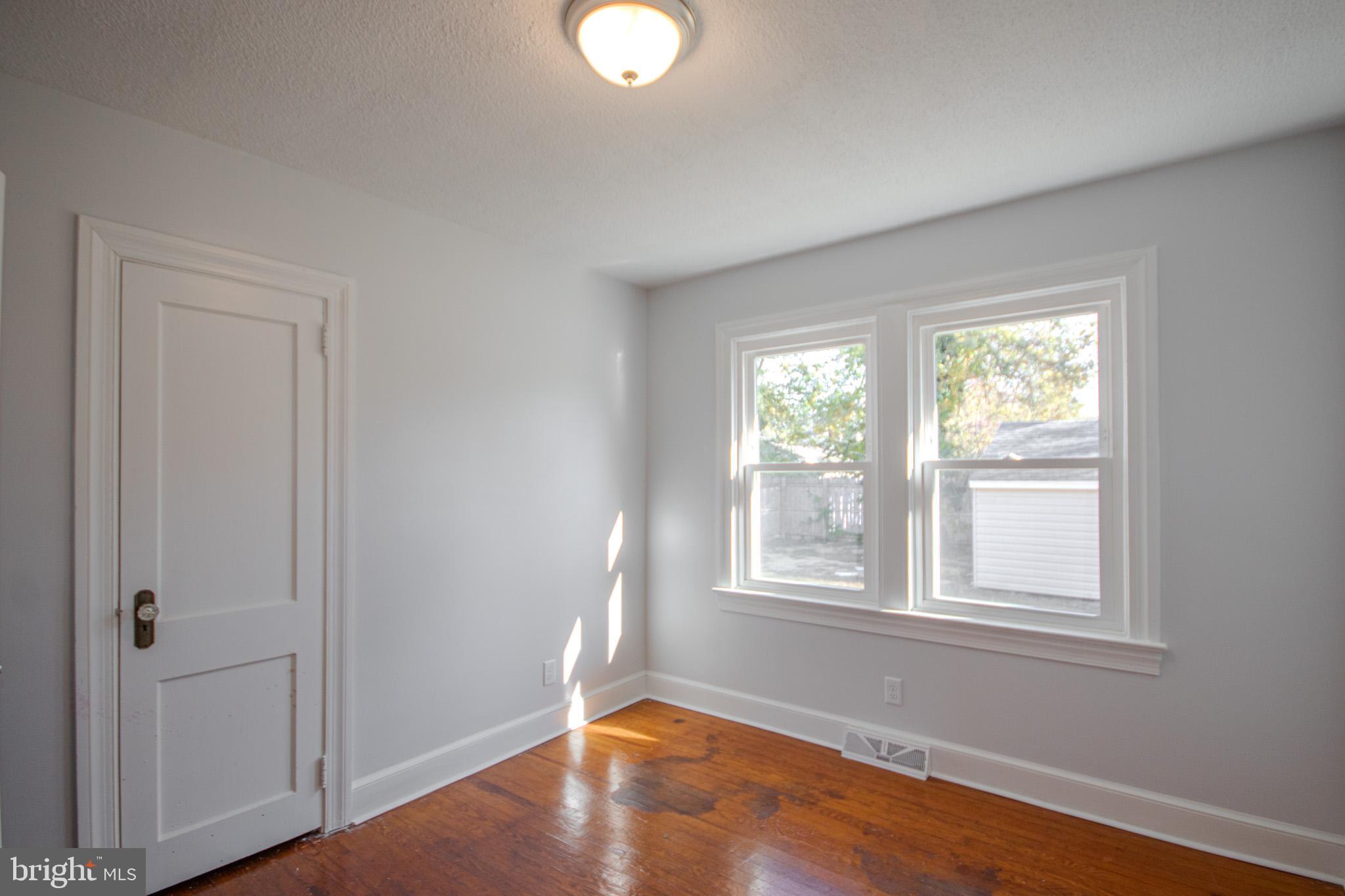 131 Truitt Street Salisbury, MD 21804 - Photo 20 of 29 an empty room with wooden floor and windows