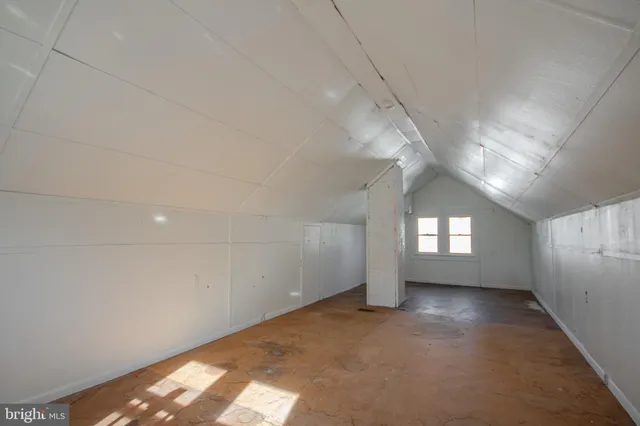 an empty room with a empty space and windows