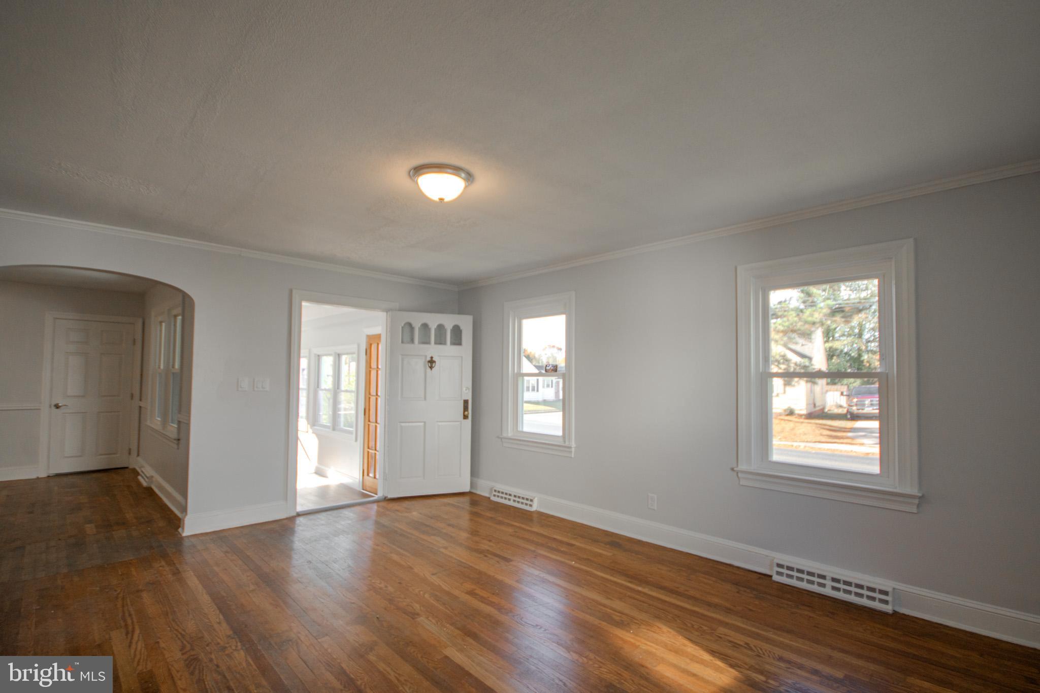 131 Truitt Street Salisbury, MD 21804 - Photo 7 of 29 an empty room with wooden floor and windows