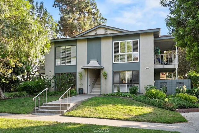 a front view of a house with garden