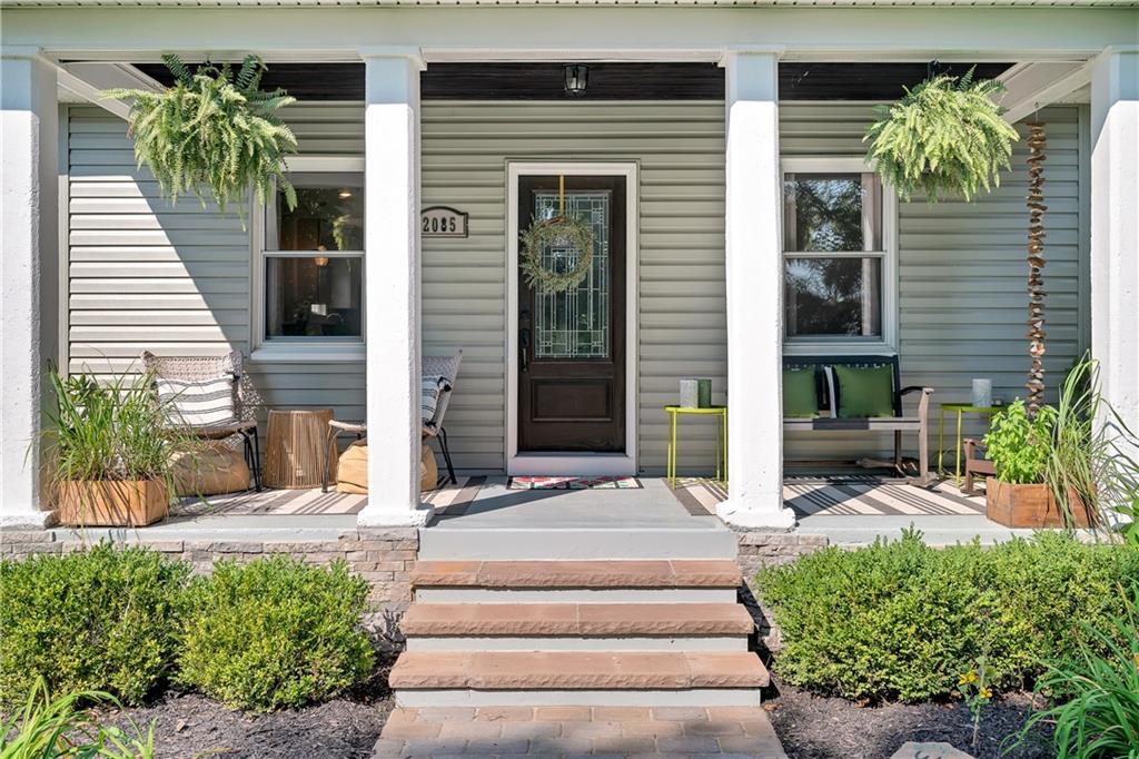 2085 Ridge Rd Extension Ambridge, PA 15003 - Photo 12 of 25 a view of a house with potted plants and a table and chairs