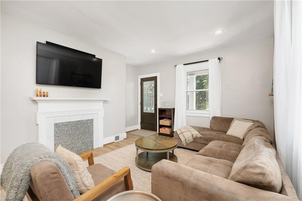 2085 Ridge Rd Extension Ambridge, PA 15003 - Photo 13 of 25 a living room with furniture a fireplace and a flat screen tv