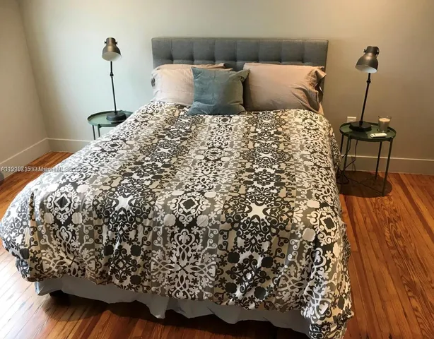 a bed sitting in a bedroom next to a window