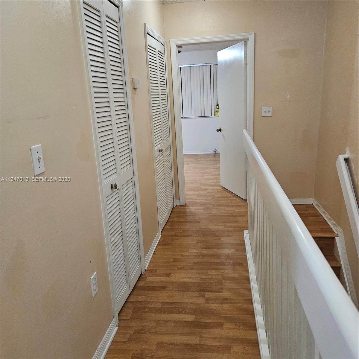 6309 Southwest 138th Place Miami, FL 33183 - Photo 16 of 17 a view of a hallway with wooden floor and staircase