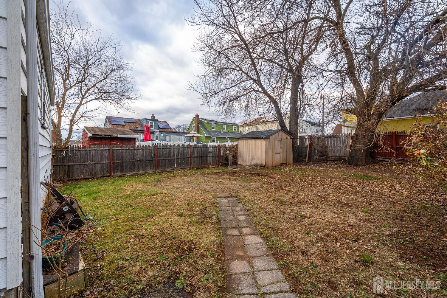 81 Larch Street Port Reading, NJ 07064 - Photo 18 of 25 a backyard of a house with lots of green space