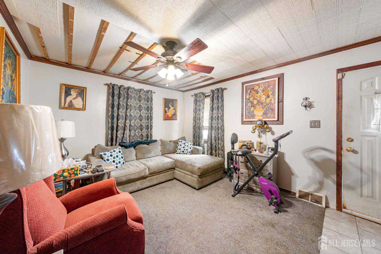 81 Larch Street Port Reading, NJ 07064 - Photo 3 of 25 a living room with furniture a couch and a window