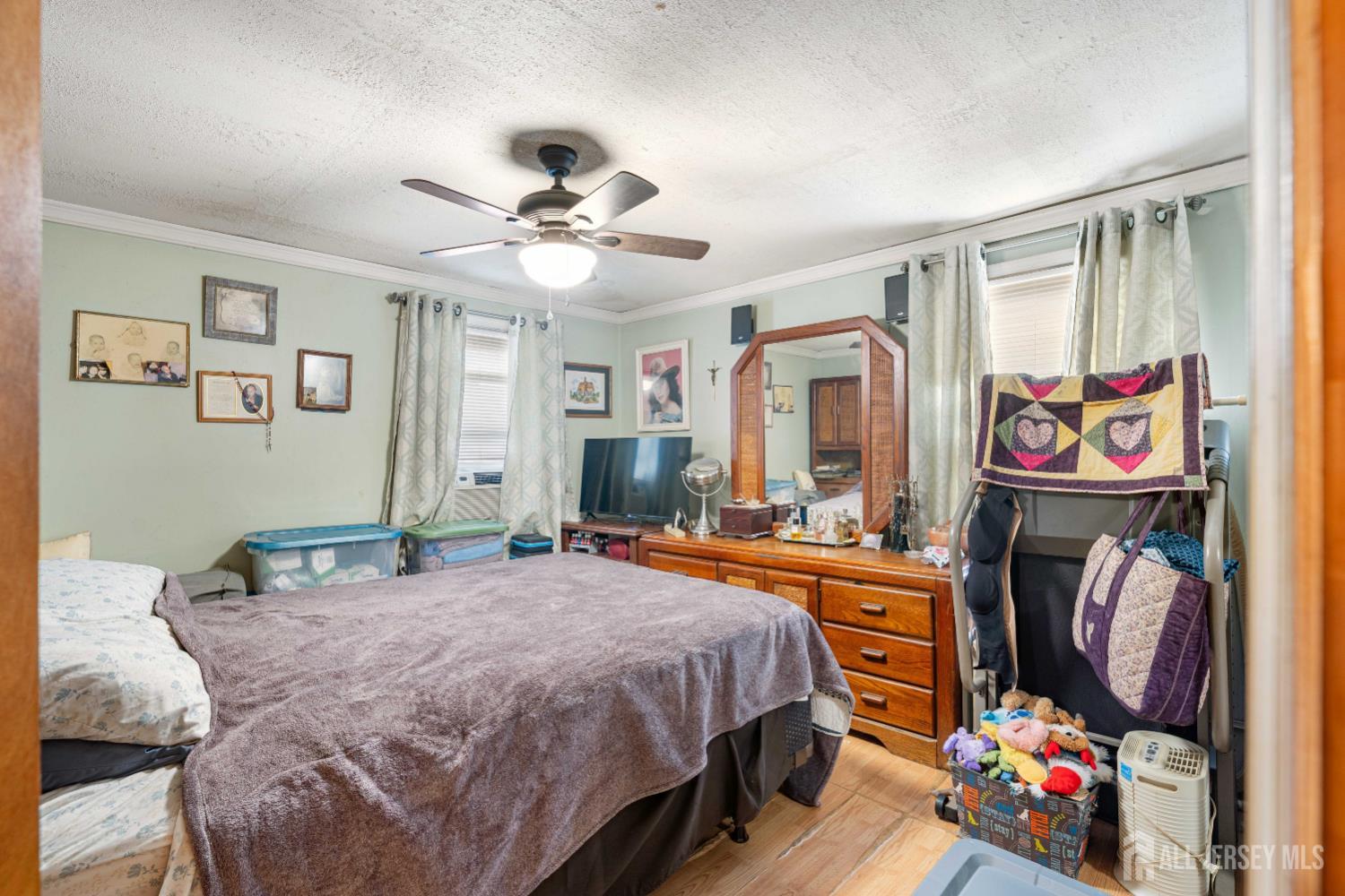 81 Larch Street Port Reading, NJ 07064 - Photo 7 of 25 a bedroom with a bed and dresser with wooden floor