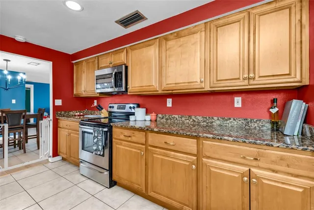 a kitchen with stainless steel appliances granite countertop a stove and a sink