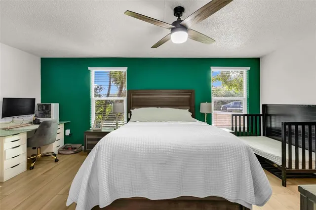 a bedroom with a large bed and a chandelier