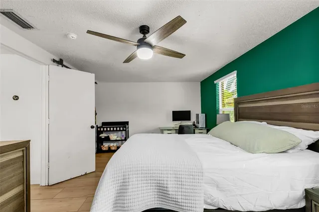 a bedroom with a bed and a chandelier