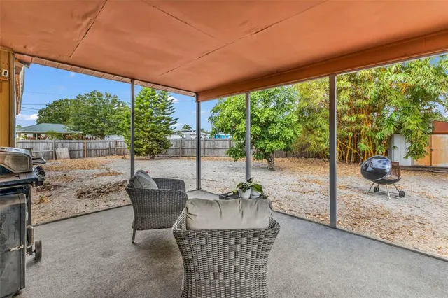 a patio with yard glass top table and chairs