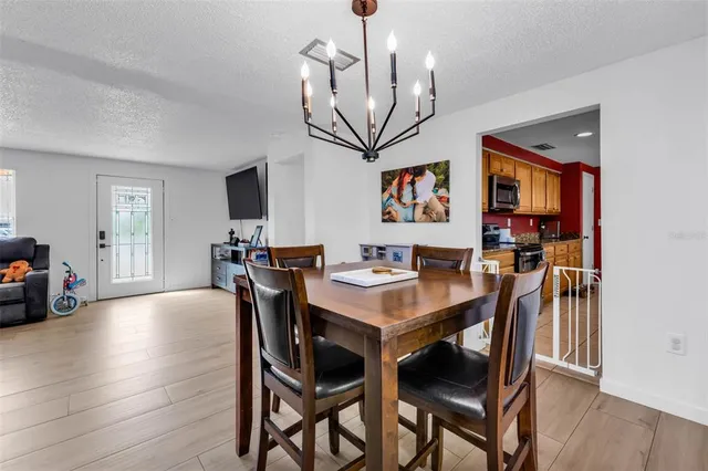 a view of a dining room with furniture and wooden floor