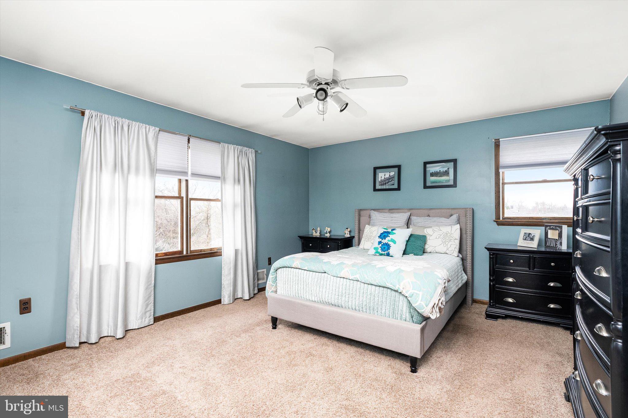 3 Eleanor Drive Wrightstown, NJ 08562 - Photo 18 of 28 a bedroom with a bed and a chandelier