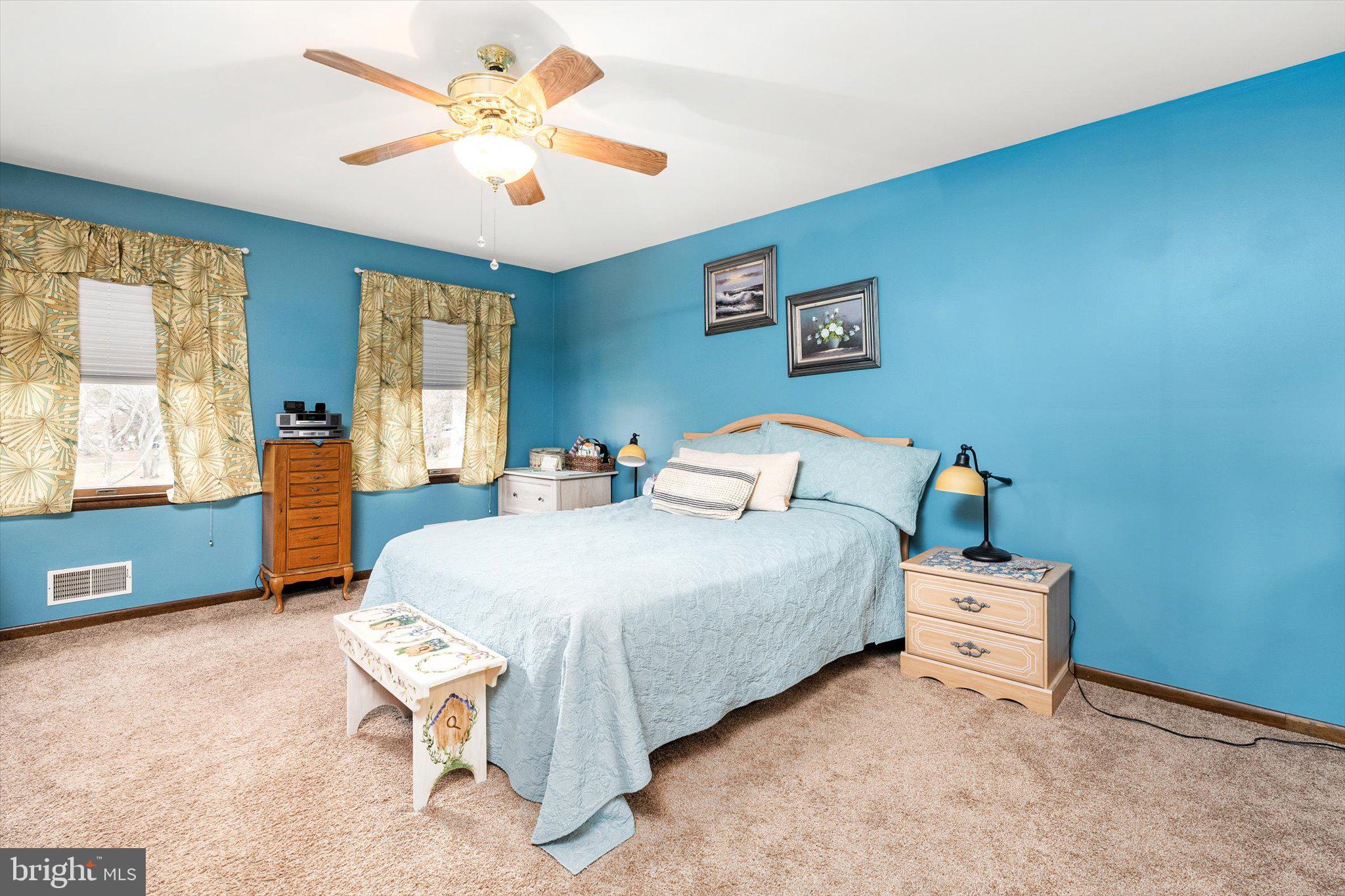 3 Eleanor Drive Wrightstown, NJ 08562 - Photo 20 of 28 a bedroom with a bed and a chandelier fan