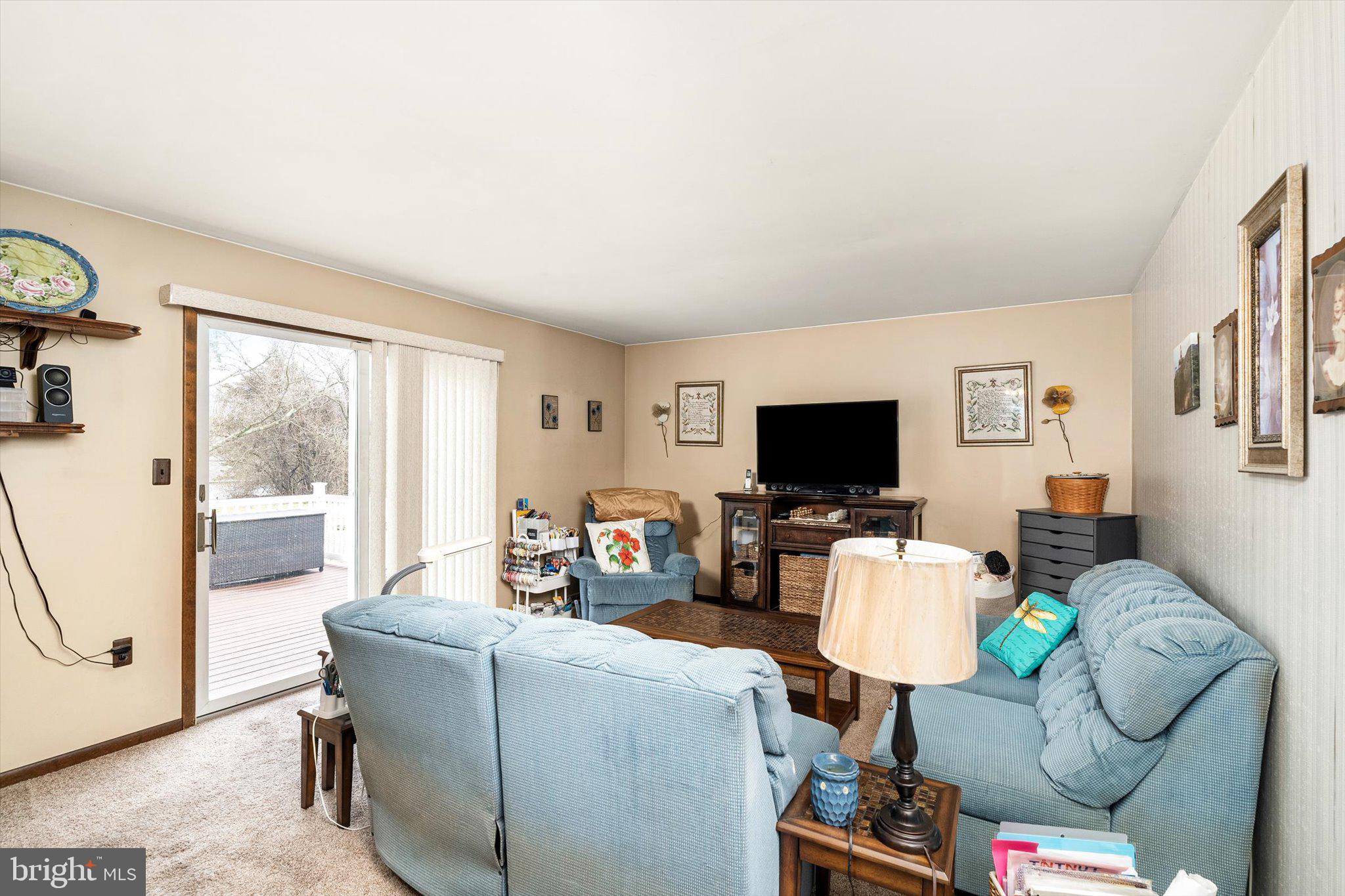3 Eleanor Drive Wrightstown, NJ 08562 - Photo 8 of 28 a living room with furniture a flat screen tv and a large window