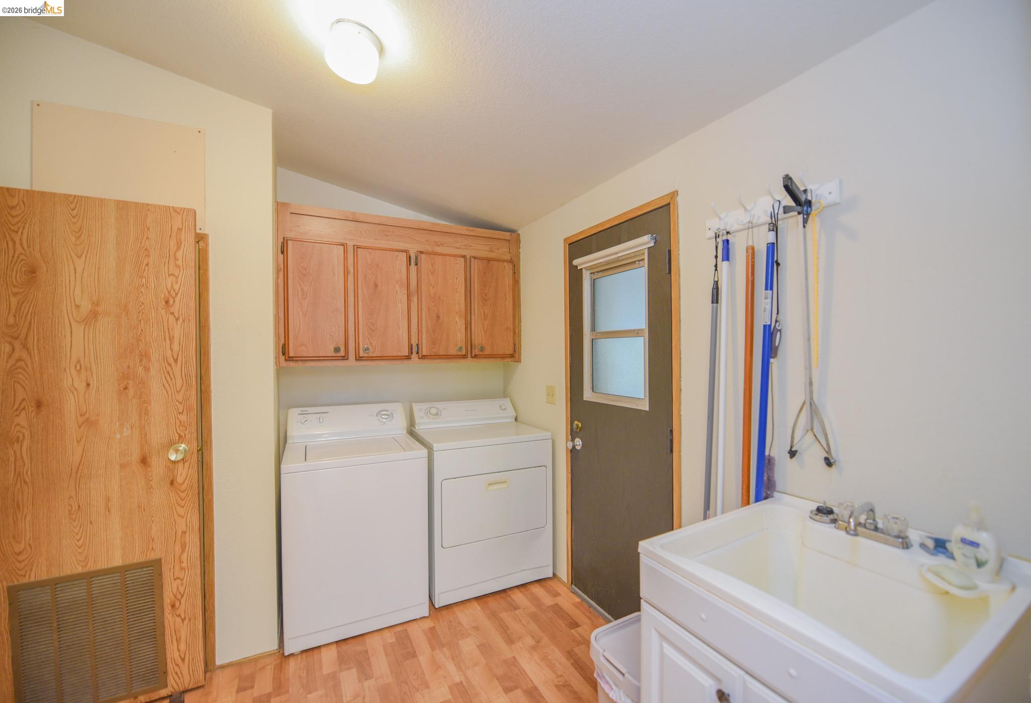 18717 Mill Villa Road, Unit 235 Jamestown, CA 95327 - Photo 13 of 26 Laundry room featuring cabinet space, washer and clothes dryer, and light wood finished floors