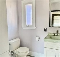 6 Hadassah Way, Unit 11/15/15 Hull, MA 02045 - Photo 7 of 12 a bathroom with a toilet sink and mirror