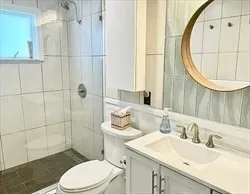 a bathroom with a sink a toilet and a mirror