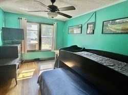 6 Hadassah Way, Unit 11/15/15 Hull, MA 02045 - Photo 9 of 12 a bedroom with a bed window and a flat tv screen