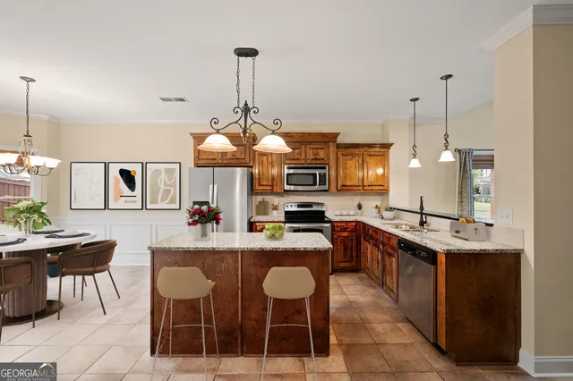 a kitchen with a dining table chairs and white cabinets