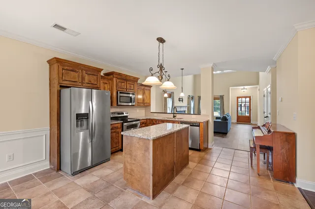 a kitchen with stainless steel appliances granite countertop a refrigerator and a sink
