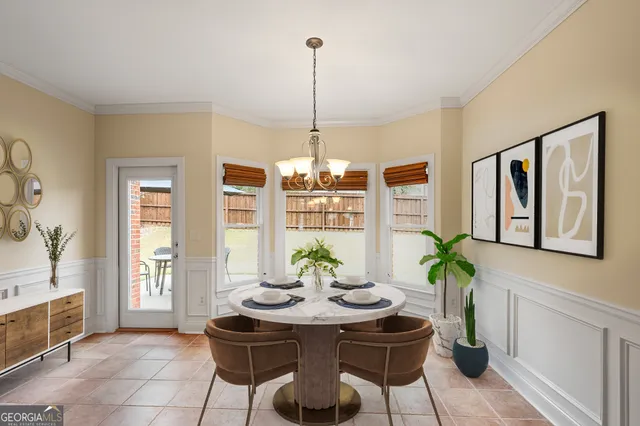 a dining room with furniture a chandelier and wooden floor