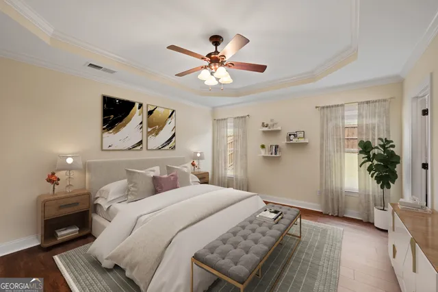 a bedroom with a large bed and a chandelier