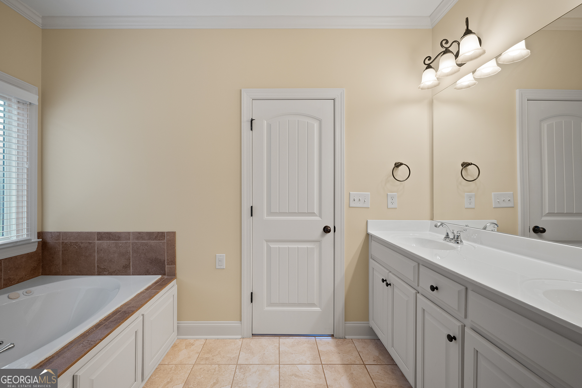 1355 Cold Tree Lane Watkinsville, GA 30677 - Photo 26 of 47 a spacious bathroom with a granite countertop sink and a mirror