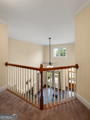 a view of staircase with rug floor