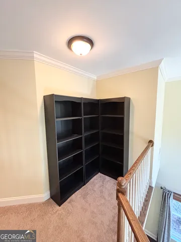 a view of an empty room with a staircase
