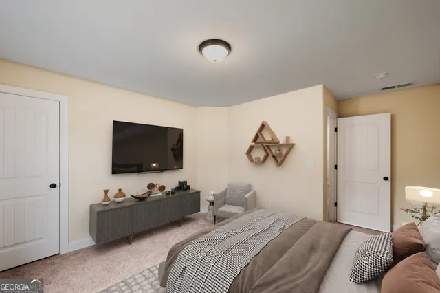 a bedroom with bed and a flat screen tv