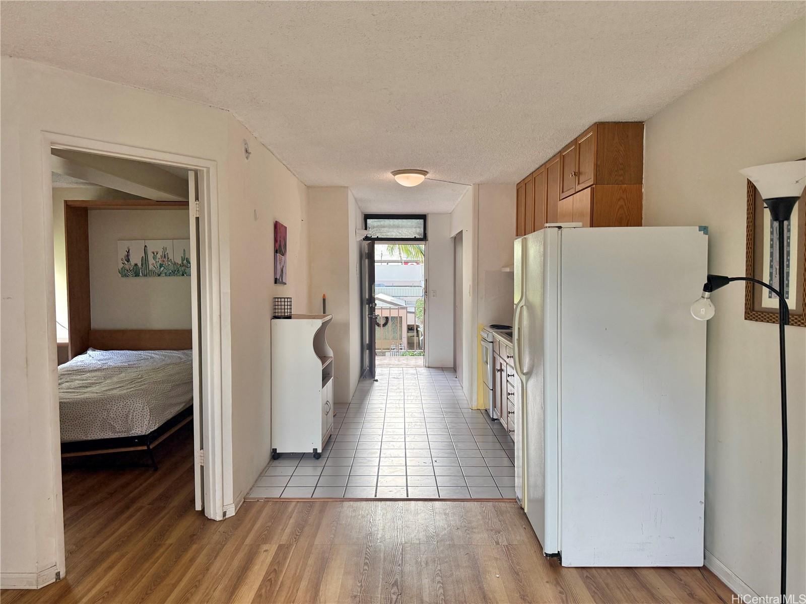 424 Walina Street, Unit 35 Honolulu, HI 96815 - Photo 5 of 15 a view of a hallway with wooden floor and a bedroom