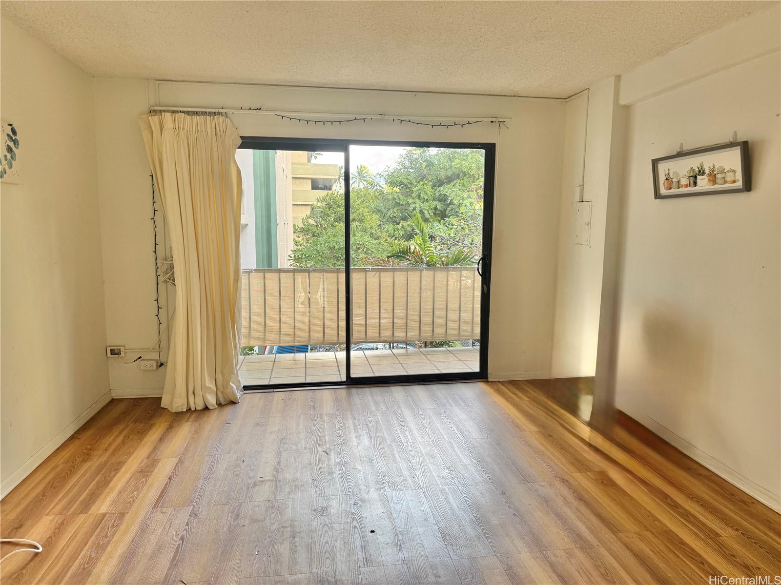 424 Walina Street, Unit 35 Honolulu, HI 96815 - Photo 6 of 15 a view of a room with wooden floor and sliding window