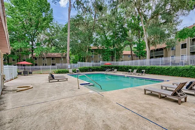 a view of backyard with outdoor seating and green space