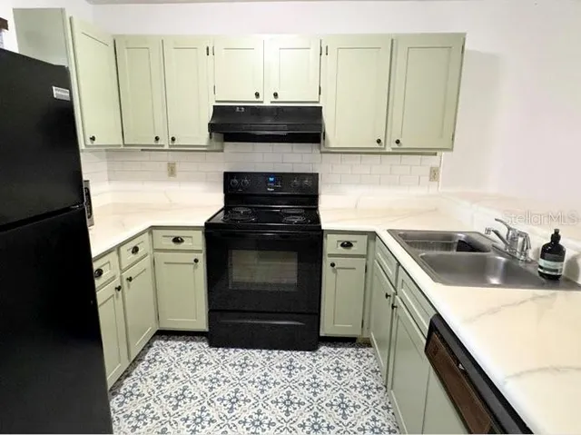 a kitchen with a sink stove and refrigerator