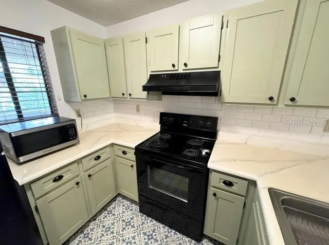 a kitchen with cabinets and appliances
