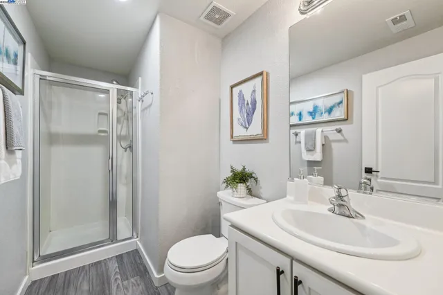 a bathroom with a sink toilet and a mirror