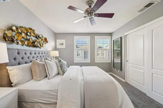 a bedroom with a large bed and a chandelier